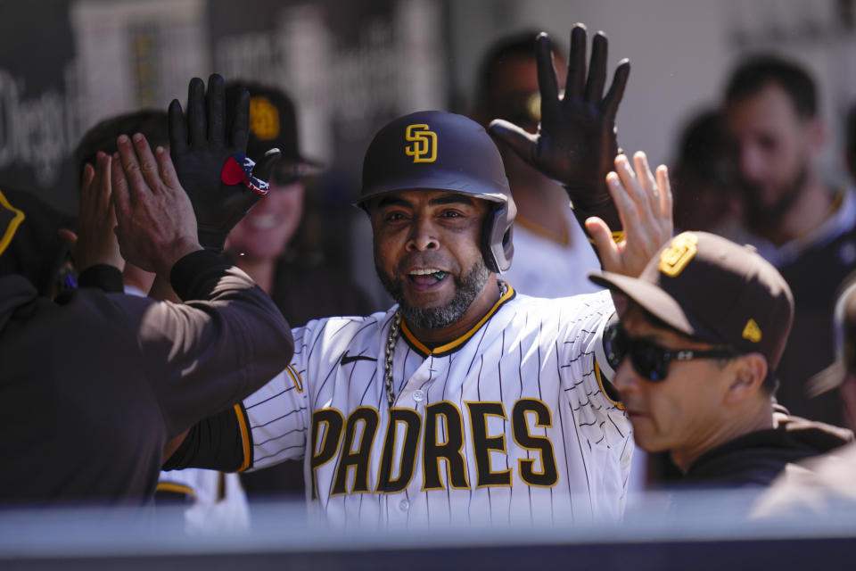 San Diego Padres' Nelson Cruz celebrates with teammates after hitting a home run during the fourth inning of a baseball game against the Arizona Diamondbacks, Tuesday, April 4, 2023, in San Diego. (AP Photo/Gregory Bull)