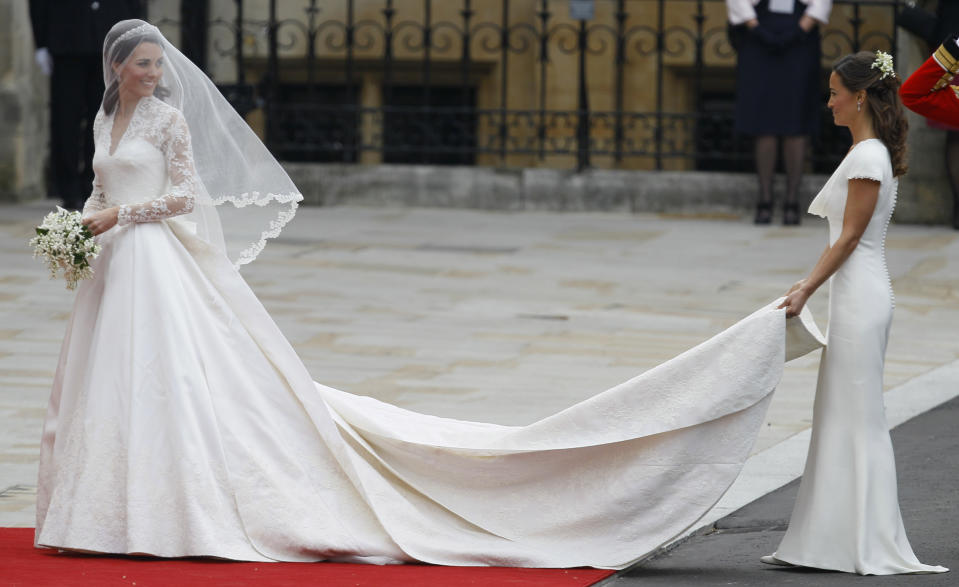 FILE - Kate Middleton, left, and accompanied by maid of honour Pippa Middleton as they arrive at Westminster Abbey at the Royal Wedding in London Friday, April 29, 2011. Attention on Princess Kate has reached levels not seen since she married Prince William in a fairy-tale wedding in 2011. An admission from Kate that she altered an official family photo triggered a backlash. (AP Photo/Alastair Grant, File)