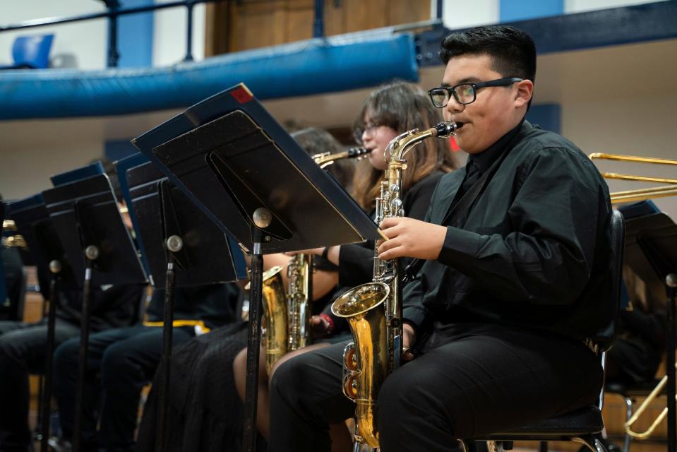 Eighth-grader Jesus Guerrero Ramos, 13, plays the saxophone during a performance to celebrate a donation of dozens of new musical instruments from The Latin Grammy Cultural Foundation and Ford Motor Company Fund at Academy of the Americas in Detroit on Dec. 8, 2022.