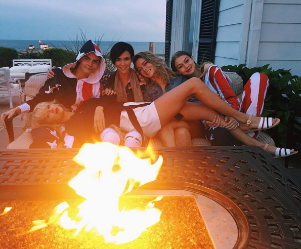 The women also posed in front of a fire with a reclining Taylor, Cara, and Gigi. (Photo: Instagram)