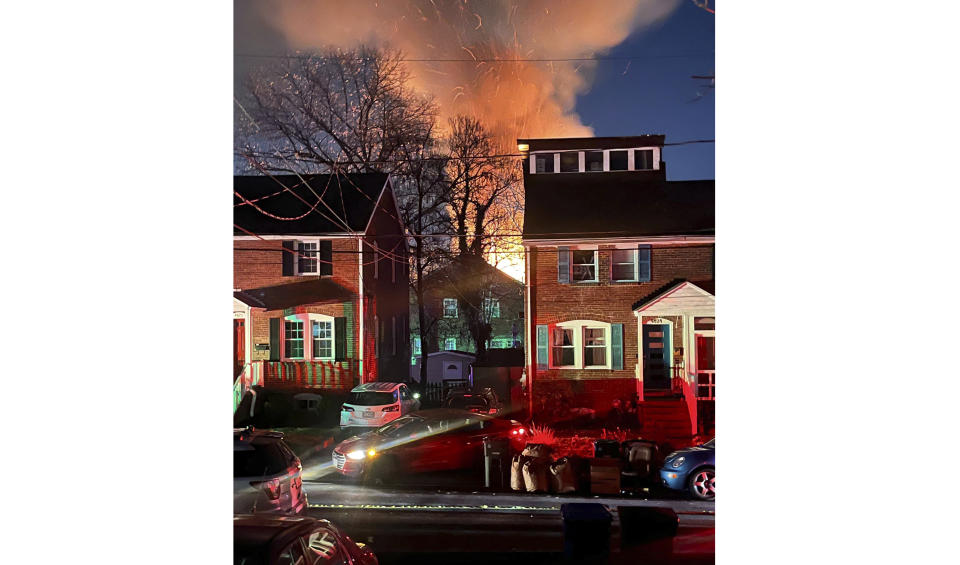 A home is seen exploding from a distance, Monday night, Dec. 4, 2023 in Arlington, Va. Arlington County Police in a Virginia suburb of the nation’s capital are investigating an explosion at a residence where officers were trying to serve a search warrant Monday. The Arlington County Police Department said in a statement that the suspect fired several shots inside the home and that an explosion happened. Arlington is located across the Potomac River from Washington, D.C. (AP Photo)