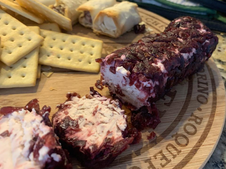 trader joes cranberry goat cheese on cutting board with crackers