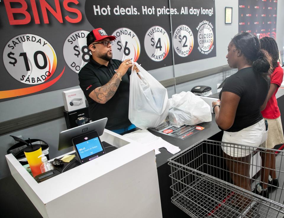 Hotbins manager Carlos Quezada helps a customer on Friday, Aug. 11, 2023, in Fort Myers.