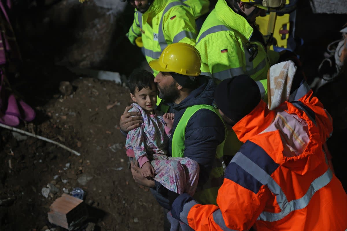 A 33 year-old mother, Serap Topal and her 5 year-old son, Mehmet Hamza Topal are rescued by the German and British rescue teams from under the rubble after 68 hours of the 7.7 magnitude Kahramanmaras earthquake in Turkey (Anadolu Agency via Getty Images)