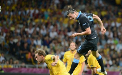 English forward Andy Carroll heads the ball to score during their Euro 2012 championships football match against Sweden at the Olympic Stadium in Kiev. A towering Carroll header midway through the opening period gave England a 1-0 lead over Sweden at half-time in Friday's crucial Euro 2012 Group D encounter in Kiev