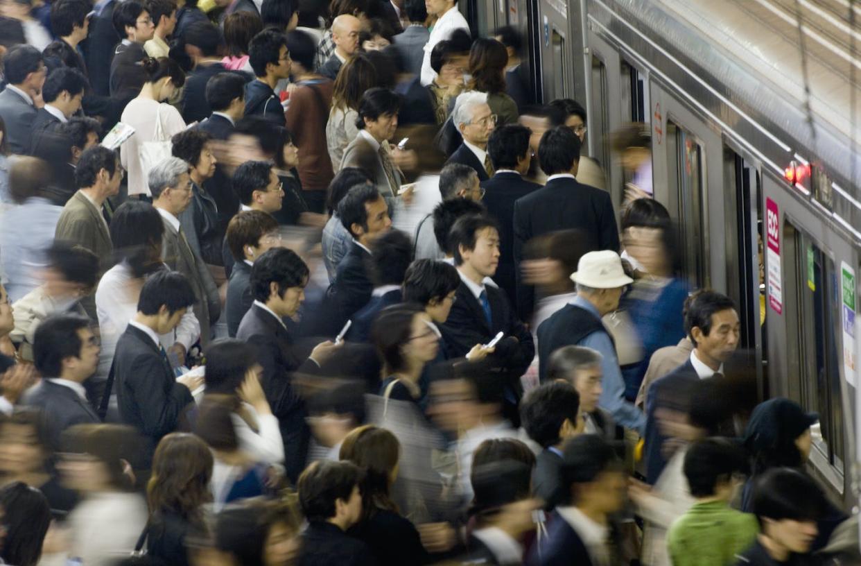 Population growth fuels knowledge, leading to new technology and energy use, fueling more population growth. <a href="https://www.gettyimages.com/detail/photo/commuters-rushing-onto-train-at-umeda-subway-royalty-free-image/521711666" rel="nofollow noopener" target="_blank" data-ylk="slk:Robert Essel/The Image Bank via Getty Images;elm:context_link;itc:0;sec:content-canvas" class="link ">Robert Essel/The Image Bank via Getty Images</a>
