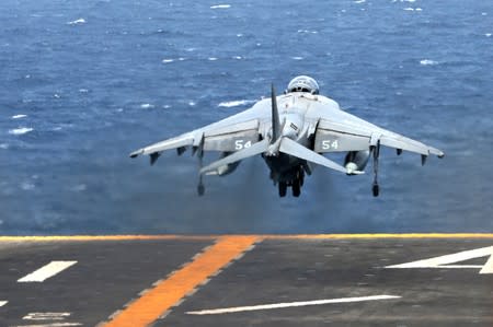 A U.S. AV-8B Harrier aircraft lakes off on the flight deck of USS Boxer (LHD-4) in the Arabian Sea off Oman