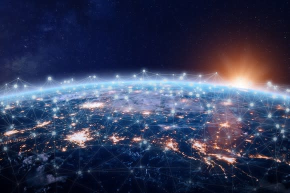 Aerial view of Earth at night with connected wireless nodes, AI/Internet of Things concept