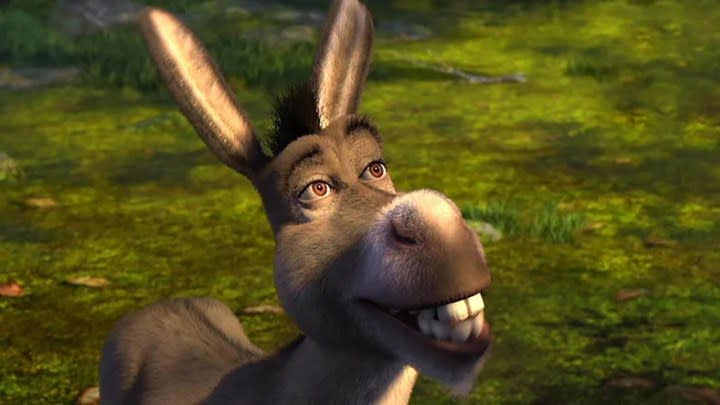 Donkey looking up and smiling in a scene from the movie Shrek.