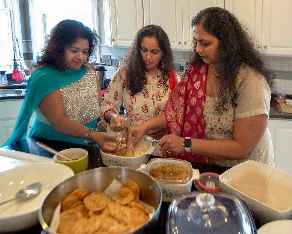 At the Reddy residence, in Warrington, Pennsylvania on Sunday, Oct. 31, 2021, friends and neighbors prepare traditional Diwali sweets. From the left: Reema Devika Nambi, Srilatha Kallam and Devika Nambi.