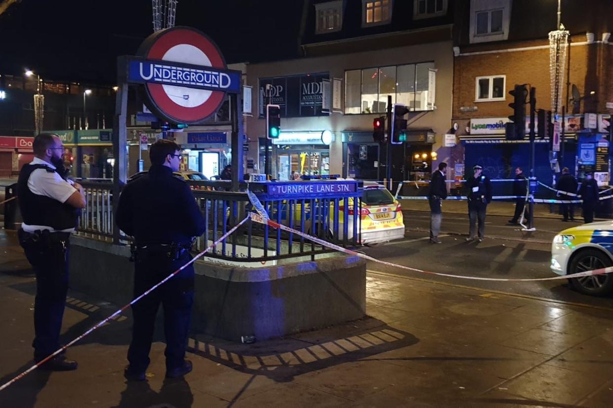 Attack: police at the scene of the shooting near Turnpike Lane station: London999