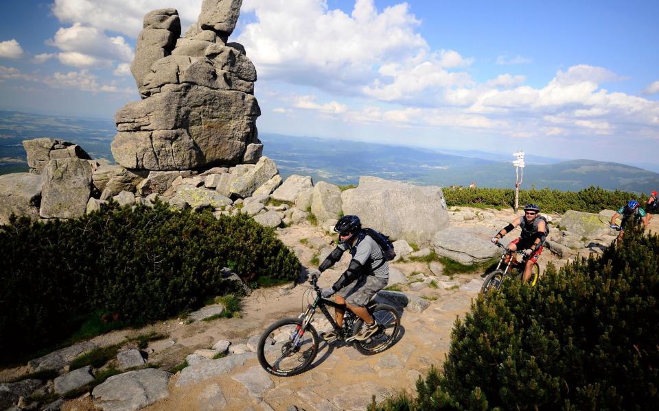 Mountain biking through the Slonecznik rock formation in the Bohemian Mountains, Lower Silesia, Poland