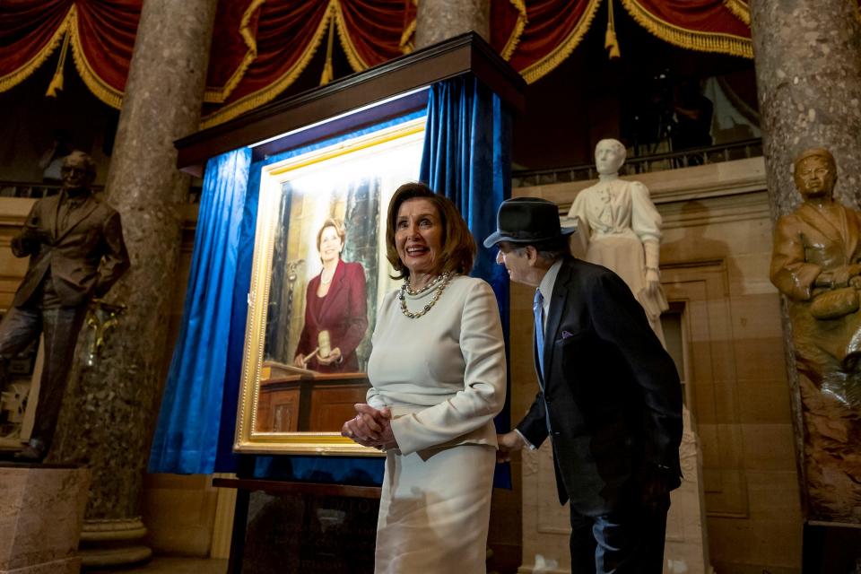 Outgoing US House Speaker Nancy Pelosi and her husband Paul unveil her official portrait during an unveiling ceremony in Statuary Hall at the US Capitol on December 14, 2022 in Washington, DC.