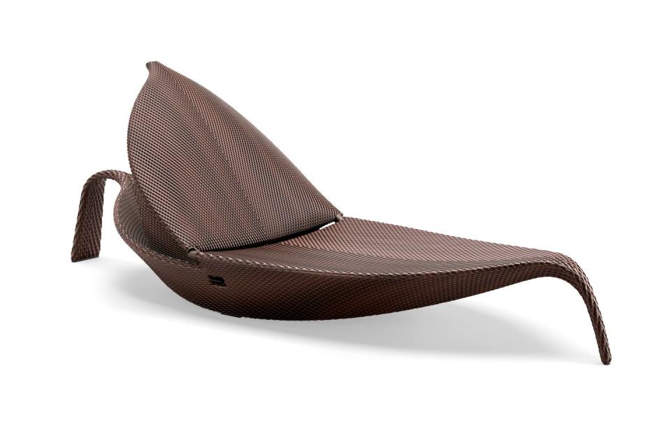 lounge chair that looks like a stylized leaf in brown tone