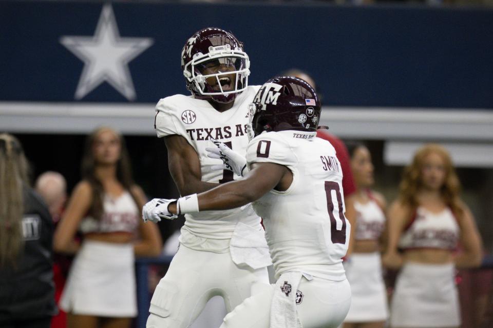 Sep 30, 2023; Arlington, Texas; Texas A&M Aggies wide receiver Evan Stewart (1) and wide receiver Ainias Smith (0) celebrate after Stewart catches a pass for a touchdown against the Arkansas Razorbacks during the first half at AT&T Stadium. Jerome Miron-USA TODAY Sports