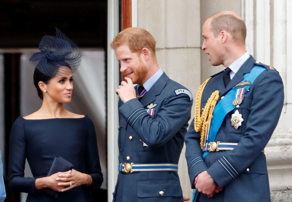 Meghan, Duchess of Sussex, Prince Harry, Duke of Sussex and Prince William, Duke of Cambridge watch a flypast to mark the centenary of the Royal Air Force from the balcony of Buckingham Palace on July 10, 2018 in London, England.