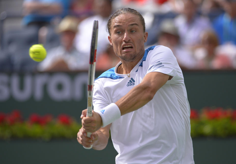 Alexandr Dolgopolov, of Ukraine, hits to Milos Raonic, of Canada, during a quarterfinal match at the BNP Paribas Open tennis tournament, Thursday, March 13, 2014, in Indian Wells, Calif. (AP Photo/Mark J. Terrill)