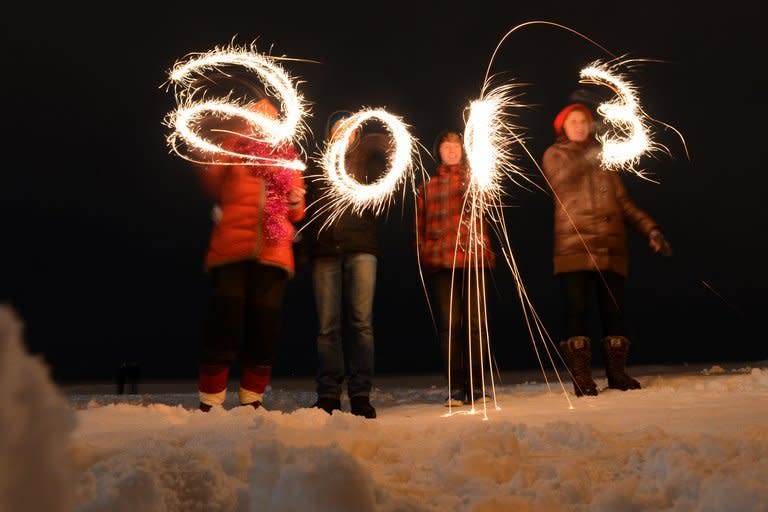 People write "2013" with sparklers as they celebrate the New Year at the shore of the Gulf of Finland in the city of Zelenogorsk in Russia early on January 1, 2013. Millions of people around the world cheered in the New Year