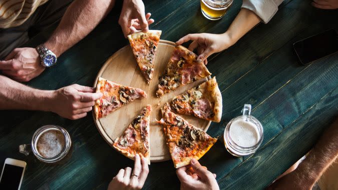 Friends having pizza in a restaurant.