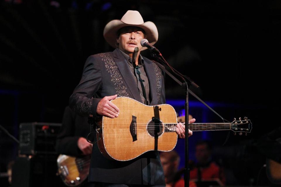 FILE - This Sept. 11, 2011 file photo shows country singer Alan Jackson performing before President Barack Obama at "A Concert for Hope" at the Kennedy Center in Washington on the 10th anniversary of the Sept. 11 attacks. The release of his latest album "Thirty Miles West" caps an emotional period for the 53-year-old and his family. His wife has now been cancer free for a year. And Jackson split with Arista Nashville, ending a two-decade partnership that produced more than 43 million albums sold. He signed with Capitol/EMI Records Nashville and "Thirty Miles West" is out on his own imprint, ACR. (AP Photo/Charles Dharapak, file)