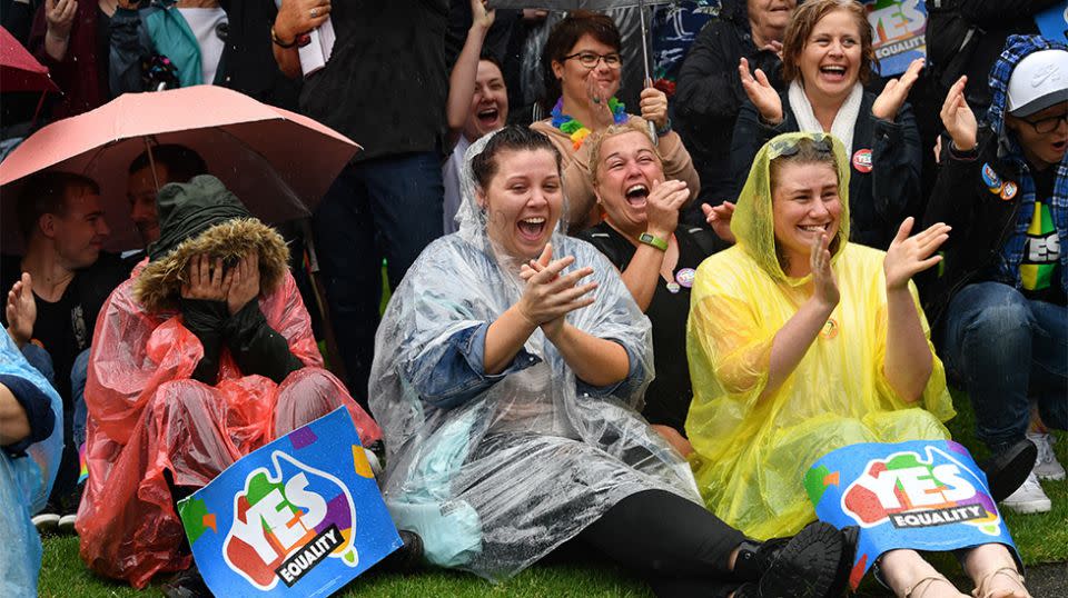 Those in Adelaide braved the weather for the announcement. Source: AAP
