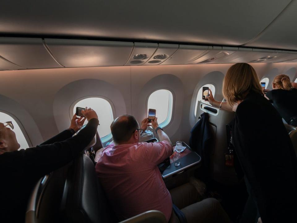 Passengers onboard a Qantas aerial tour over iconic Australian destinations.