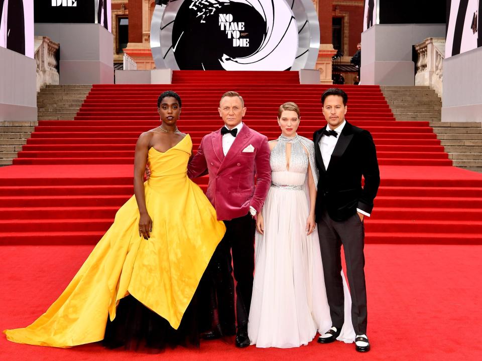 Lashana Lynch, Daniel Craig, Lea Seydoux, and Cary Joji Fukunaga standing on red carpet