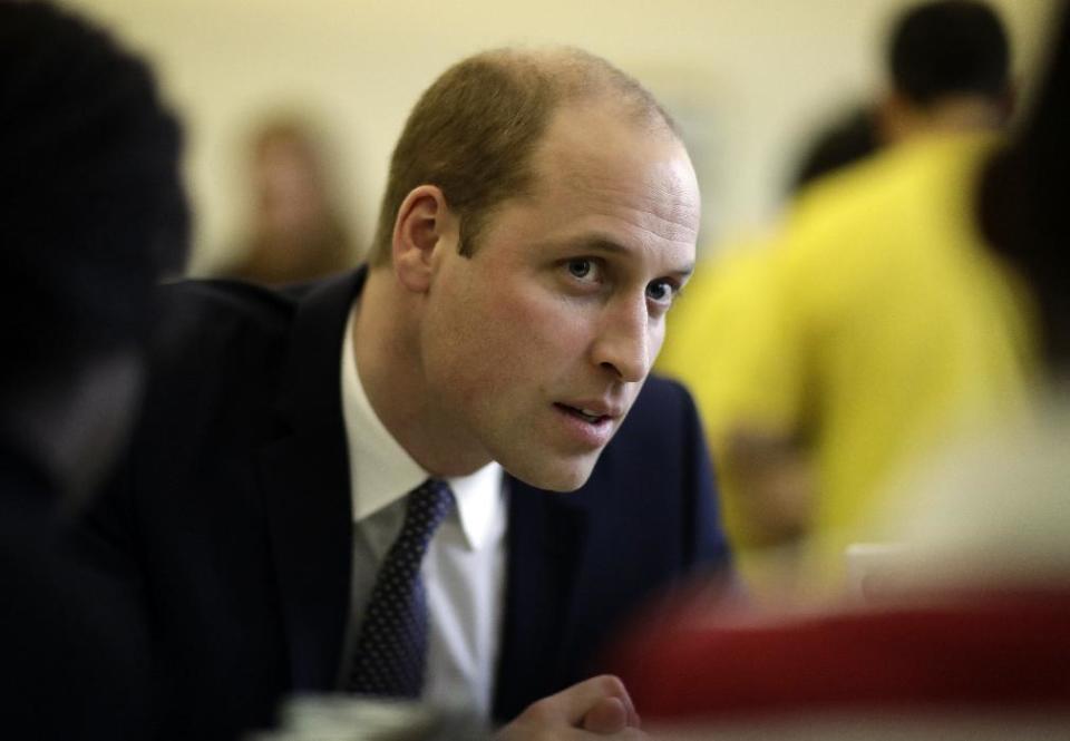 Britain's Prince William speaks with families who've experienced bereavement during his visit to a Child Bereavement UK Centre in Stratford in east London, Wednesday, Jan. 11, 2017. Prince William has been the royal patron of the Child Bereavement UK organisation since 2009. It supports families and educates professionals when a baby or child of any age dies or is dying, or when a child is facing bereavement. (AP Photo/Matt Dunham, Pool)