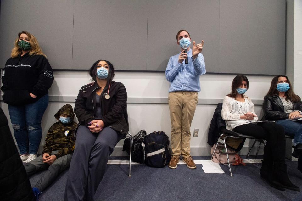 Eric Page, center, with microphone, asks a question during the public study session of the Millcreek Township School Board, on Feb. 22, at the Millcreek Education Center. The board was considering making recommendations that masks be optional in the Millcreek Township School District beginning March 1. The board voted on Feb. 28 to make masks optional.