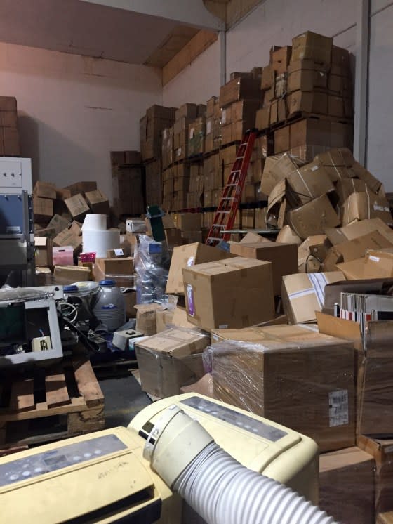 This March 16, 2023, photo provided by the city of Reedley, Calif., shows boxes and other equipment inside a now-shuttered medical lab with Chinese owners that officials say was operating illegally. The discovery in December of the lab producing pregnancy and COVID-19 tests to be sold online was the beginning of a case that would become an online firestorm of conspiracy theories and misinformation about China trying to engineer biological weapons in rural America. <span class="copyright">Courtesy of City of Reedley via AP</span>