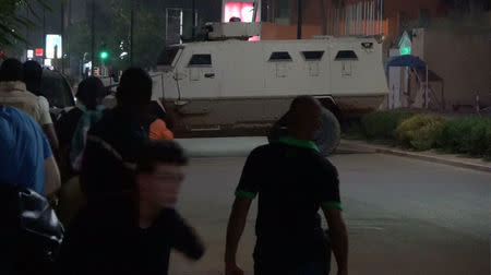 An armoured vehicle opens fire in the direction of a restaurant following an attack by gunmen on the restaurant in Ouagadougou, Burkina Faso, in this still frame taken from video August 13, 2017. REUTERS/Reuters TV