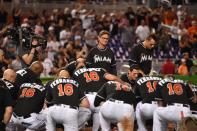 <p>Miami Marlins manager Don Mattingly watches as his team takes a knee around the pitchers mound to honor teammate starting pitcher Jose Fernandez after defeating the New York Mets 7-3 at Marlins Park. Mandatory Credit: Jasen Vinlove-USA TODAY Sports </p>