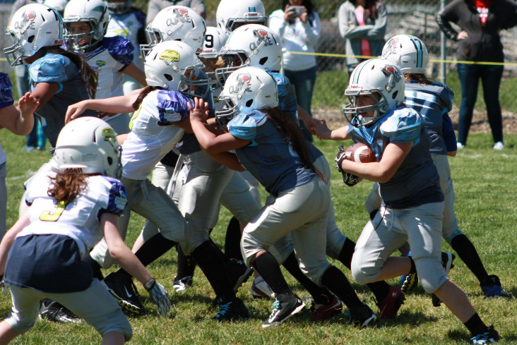 Jennasey Hargis carries the ball during a Utah Girls Tackle Football League. (Photo courtesy of Amanda Rush)