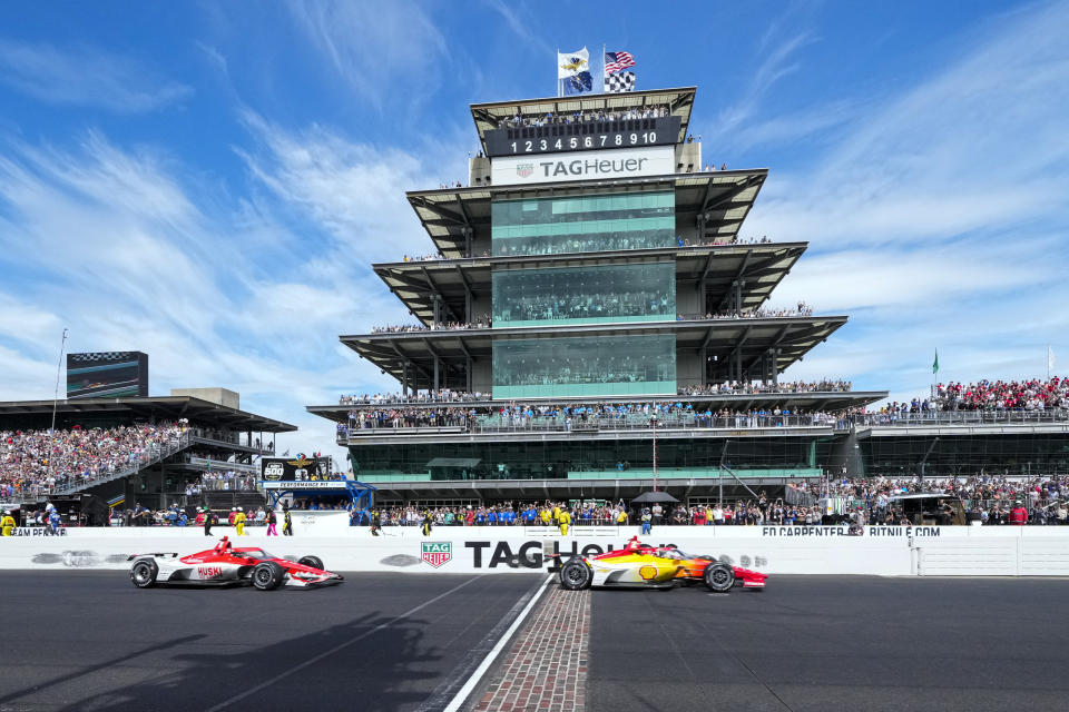 Josef Newgarden, right, crosses the finish line in front of Marcus Ericsson, of Sweden, to win the Indianapolis 500 auto race at Indianapolis Motor Speedway in Indianapolis, Sunday, May 28, 2023. (AP Photo/AJ Mast)