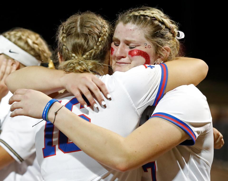 Roncalli Royals Ann Marie Meek (16) and Roncalli Royals Keagan Rothrock (7) hug after the IHSAA Class 4A Softball State Final against the Penn Kingsmen, Saturday, June 10, 2023, at Purdue University’s Bittinger Stadium in West Lafayette, Ind. Penn won 2-1 in nine innings.