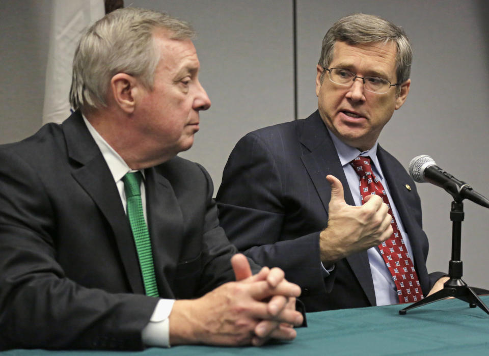 FILE - In this Nov. 25, 2013 file photo, U.S. Senators Dick Durbin, D-Ill., left, and Mark Kirk, R-Ill., speak at a joint news conference in Chicago. Both Durbin and Kirk have proposed naming the Bureau of Alcohol, Tobacco, Firearms and Explosives in Washington after Prohibition-era crime fighter Eliot Ness, but a prominent Chicago alderman and others point to evidence that Ness’ role in the demise of Chicago mobster Al Capone was as mythical as Mrs. O’Leary’s cow starting the Great Chicago Fire and are trying to convince the senators to drop the whole thing. The senators are not backing down, though, insisting he deserves it anyway. (AP Photo/M. Spencer Green, File)