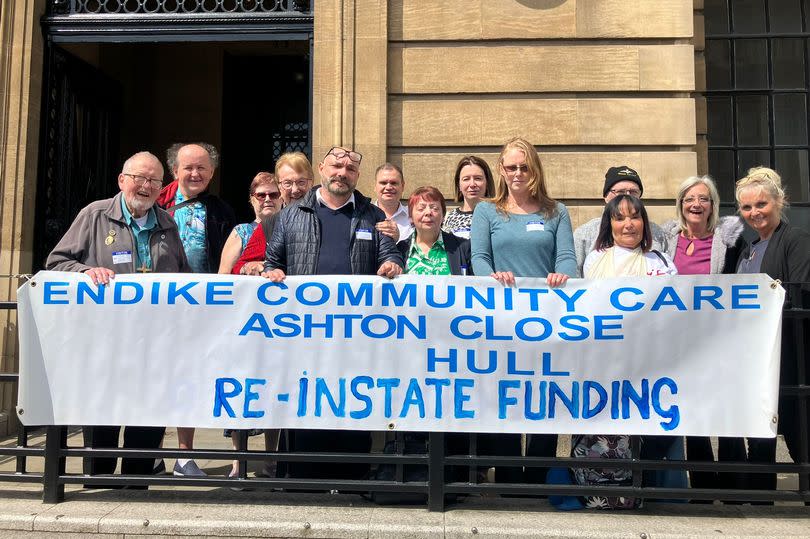 Trustees for Endike Community Care and relatives of the people it cares for outside the Guildhall in Lowgate, Hull