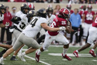 Indiana's Josh Henderson (26) runs past Purdue's Yanni Karlaftis (14) during the first half of an NCAA college football game, Saturday, Nov. 26, 2022, in Bloomington, Ind. (AP Photo/Darron Cummings)