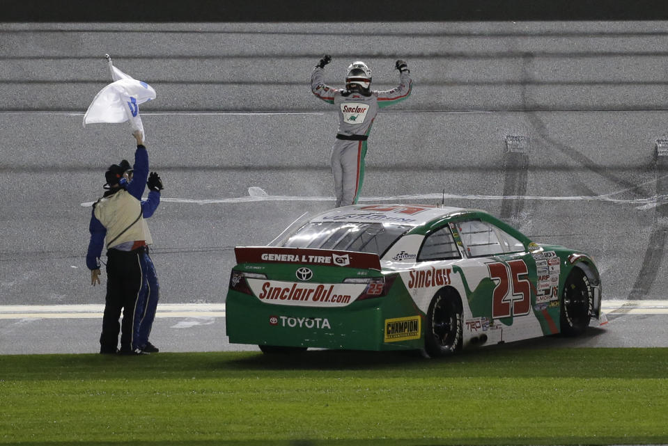 Michael Self, right, celebrates with crew members in front of fans after winning the ARCA auto race at Daytona International Speedway, Saturday, Feb. 8, 2020, in Daytona Beach, Fla. (AP Photo/Terry Renna)