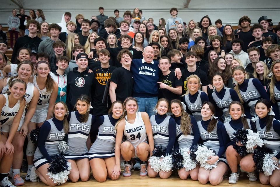 Coach Donald Dodgen, Farragut High School athletics director, poses for portraits with the student section while being honored during a game in Farragut, Tenn. on Tuesday, Jan. 25, 2022. The school's gym floor was named in honor of the longtime coach.