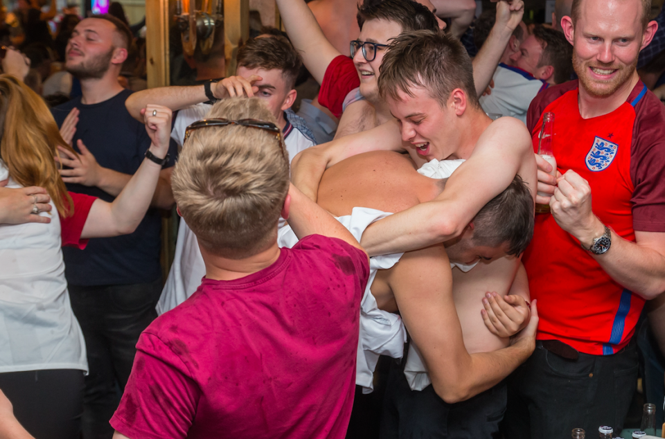 <p>Fans in Mooch Bar in Birmingham go shirtless in celebration.<br> (Picture: SWNS) </p>