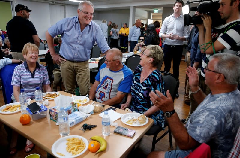 Australia's Prime Minister Scott Morrison talks to locals during a visit to Club Taree Evacuation Centre in Taree