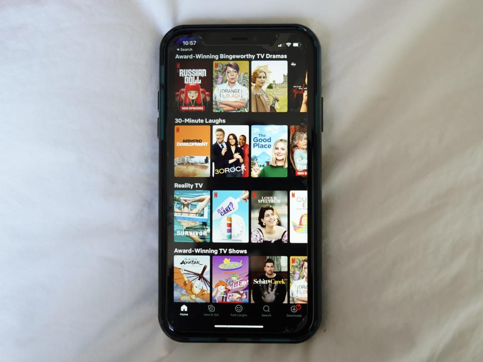 Netflix selections on a black iPhone with a white background