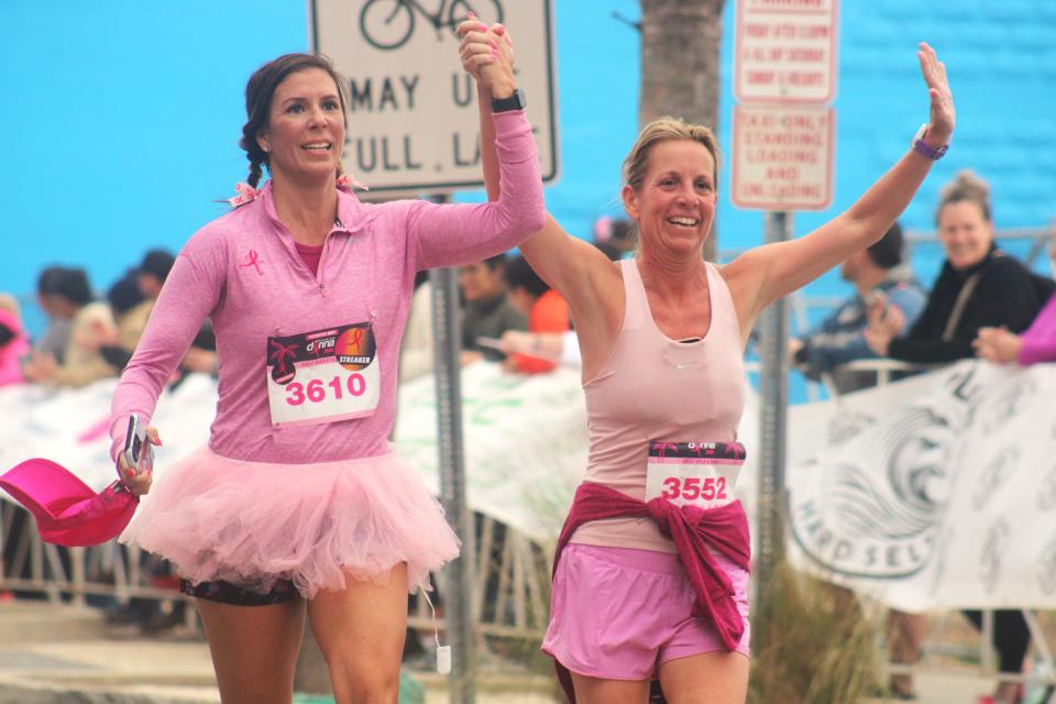 Runners cross the finish line at the Donna Marathon in Jacksonville Beach on Sunday morning.