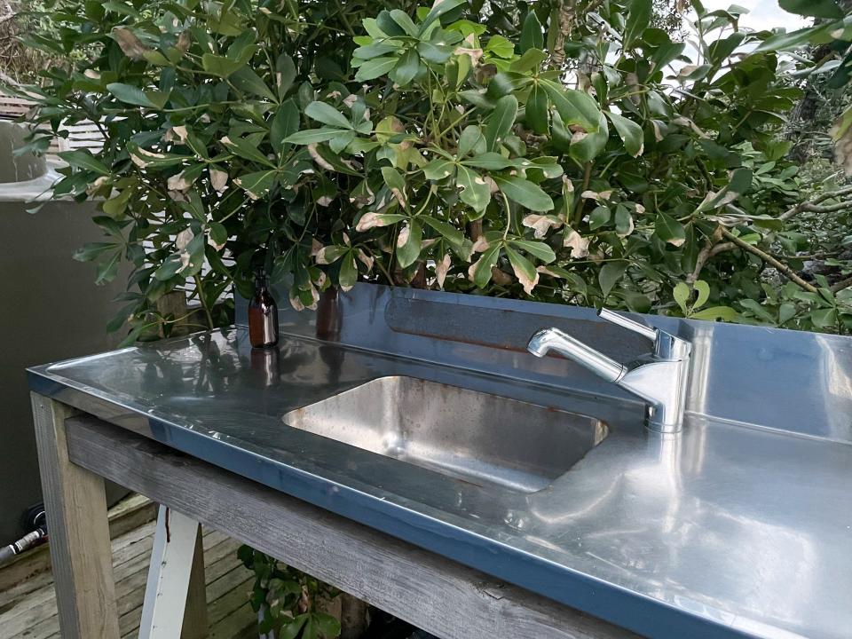 Behind the tiny house was an outdoor sink and another outdoor shower.