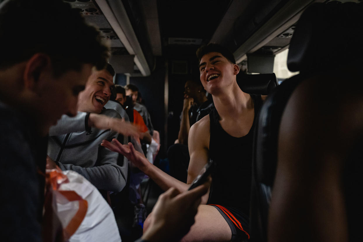 Blake Peters (L) and Jack Scott (R) laugh and embrace on the team bus on their way to the KFC YUM! Center in Louisville, Kentucky on March 23, 2023.