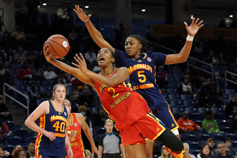 West girl's Ashlon Jackson (2) drives to the basket past East girl's Ashlyn Watkins in the first half of the McDonald's All-American Girls basketball game Tuesday, March 29, 2022, in Chicago. (AP Photo/Charles Rex Arbogast)