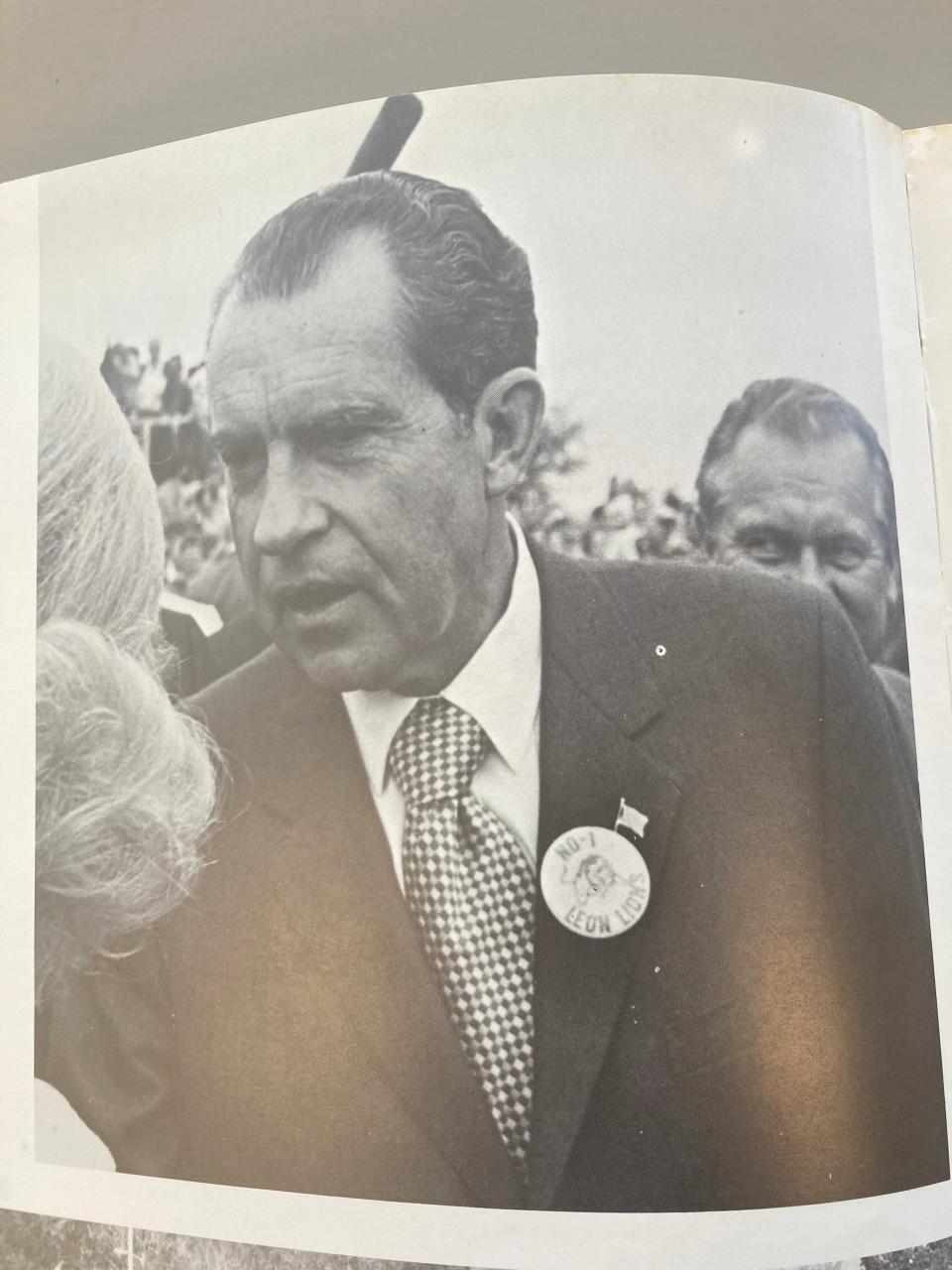Photo from Leon High yearbook. President Richard Nixon wears a Leon Lions pin during his 1971 visit, at which the Marching Redcoats performed.