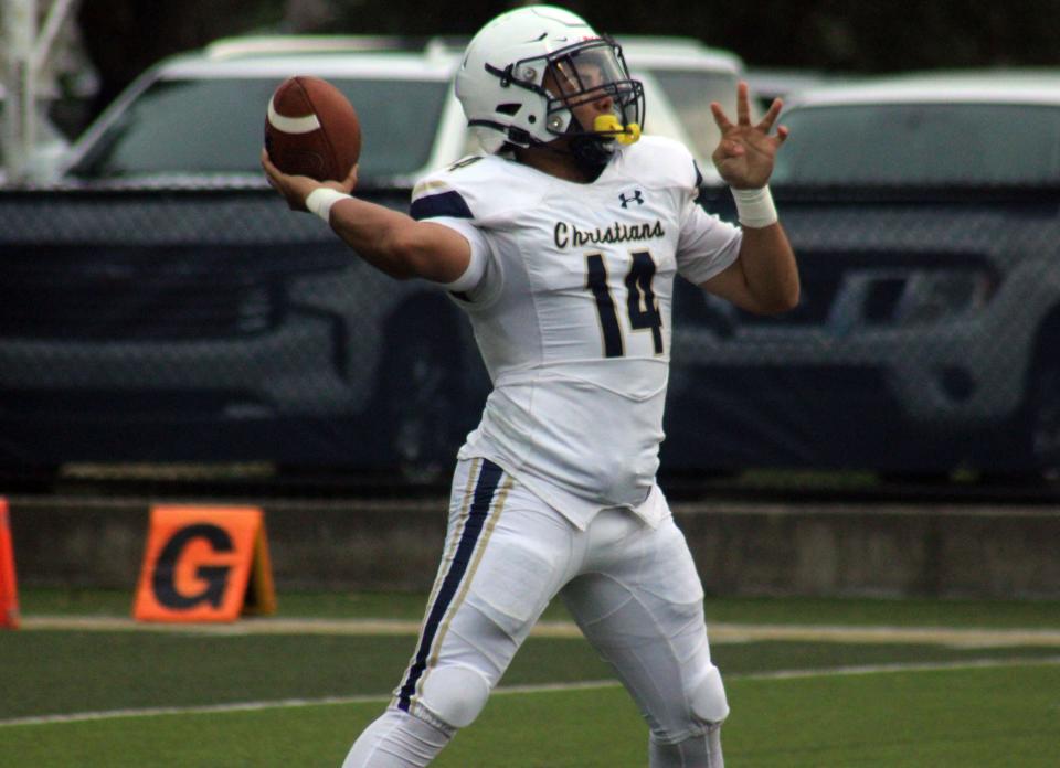 University Christian quarterback Dwayne Stuckey (14) throws a pass downfield against Mayo Lafayette in spring football.