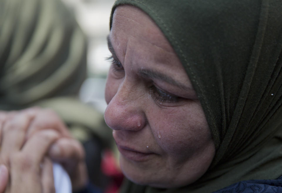 FILE - In this March 21, 2019 file photo, a relative of Palestinian Ahmad Manasra cries during his funeral in the West Bank village of Wad Fokin, near Bethlehem.In August 2020, Israeli military prosecutors offered three months of community service to a soldier who shot and killed Manasra, an unarmed Palestinian man who exited his vehicle to assist a second motorist who had also been shot -- in a case that has drawn renewed attention to a justice system that Palestinians and human rights activists say has created an atmosphere of impunity. The deal is now being reviewed by the Israeli Supreme Court. (AP Photo/Nasser Nasser, File)